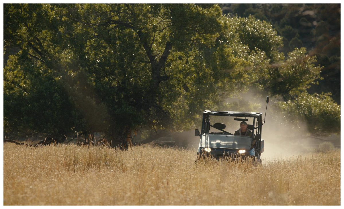 Side by side with the weBoost SxS antenna crossing a dusty ranch field