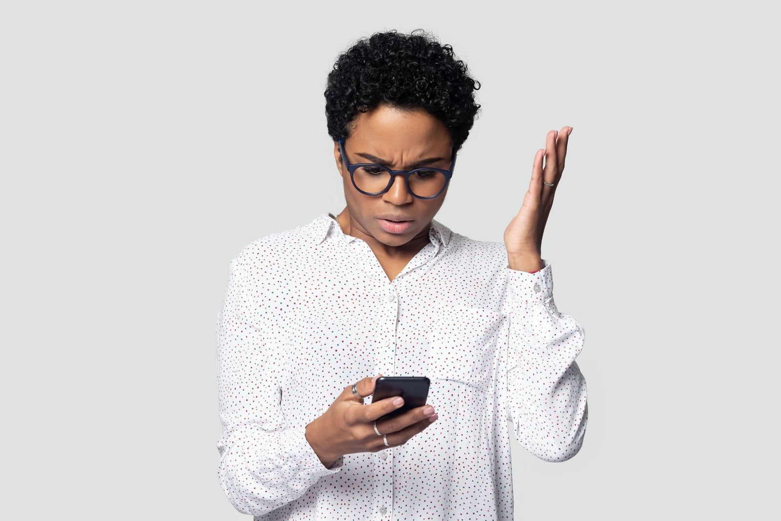Person frowning at a phone with a poor cell connection