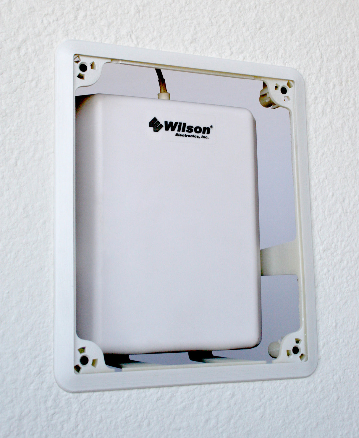 Installed in a wall with a panel antenna.  Front cover not present.