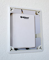 Installed in a wall with a panel antenna.  Front cover not present.